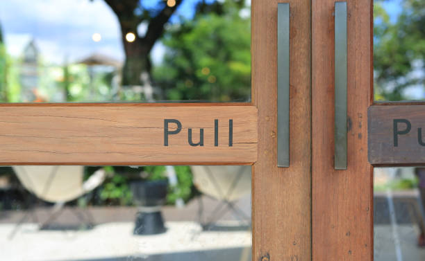 istock Glass door of restaurant with text pull on wood. 1308613327