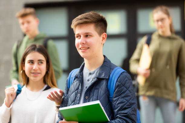 istock Smiling teenagers walking outside after lessons 1308615071