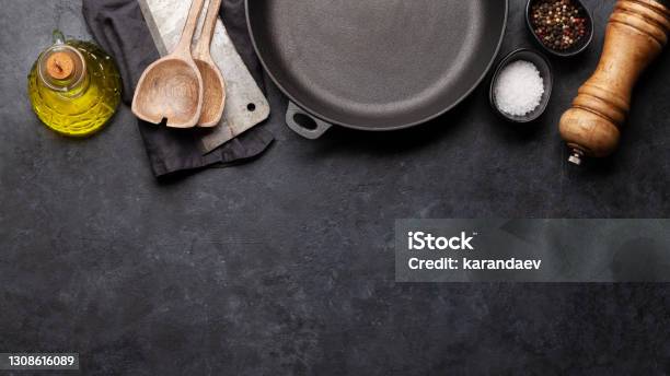 Frying Pan Utensils And Ingredients On Kitchen Table Stock Photo - Download Image Now