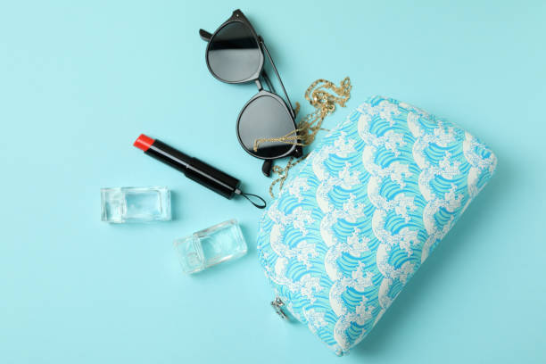 istock Cosmetic bag and female accessories on blue background 1308616214