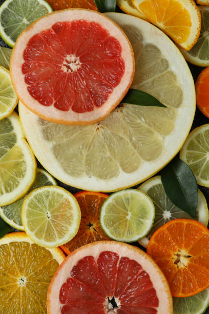 istock Ripe citrus slices on whole background, top view 1308617359