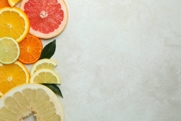 istock Ripe citrus slices on white textured background 1308617745