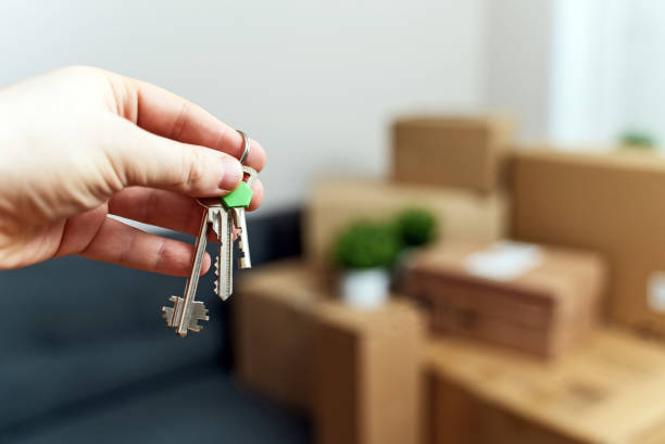 istock Hand with house key. Real estate and moving concept. 1308618402