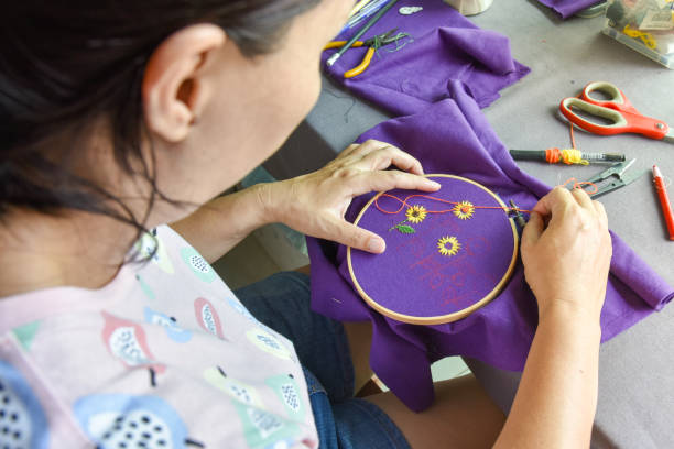 istock woman sewing handcraft of sunflower pattern 1308619246