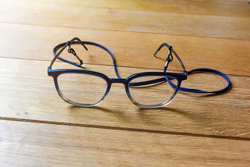 Clear Eyeglasses, Glasses transparent dark blue Frame Vintage Style with neck strap on Wood Background