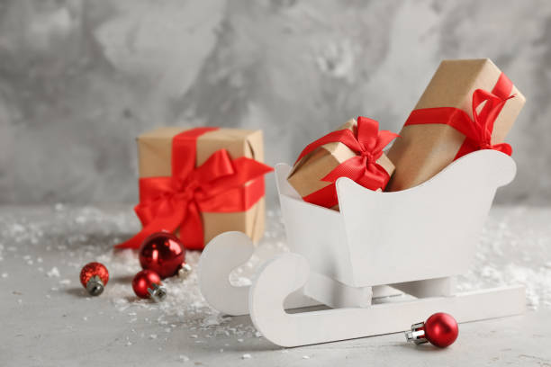 istock Beautiful Christmas composition with miniature sleigh on light table 1308619423