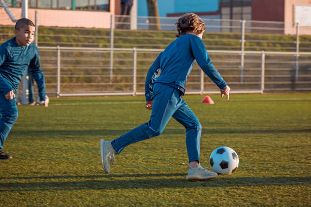 istock Two young boys training hard on the football pitch 1308619648