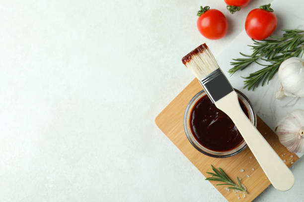 istock Concept of cooking with barbecue sauce on white textured table 1308620667