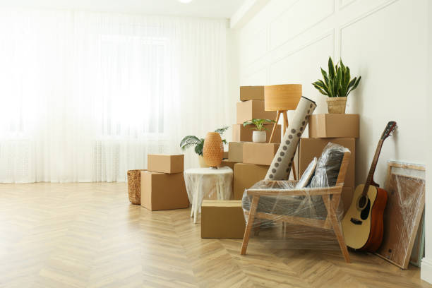 istock Cardboard boxes and household stuff indoors, space for text. Moving day 1308621024