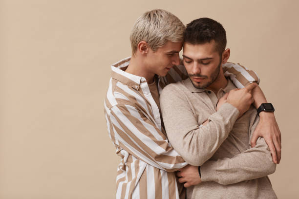 istock Gay Couple Embracing in Studio 1308621298