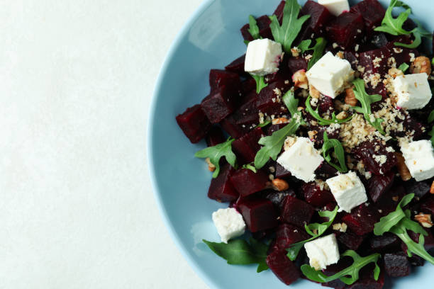 istock Concept of tasty eating with beet salad on white textured table 1308622014