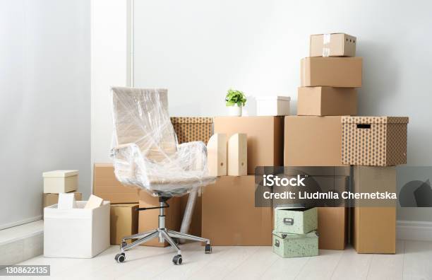 Cardboard Boxes And Packed Chair Indoors Moving Day Stock Photo - Download Image Now