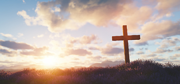 Cross at sunset religion and faith. Christian symbol.