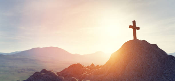 istock Cross on mountain peak at sunset christian religion 1308622978