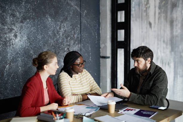 istock Busdiness Manager Talking to Colleagues 1308625111