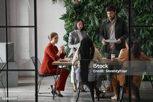 Diverse Business Team In Graphic Office Stock Photo - Download Image Now - Office, Meeting, Teamwork