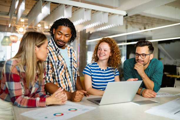istock Business people having fun and chatting at workplace office 1308626380