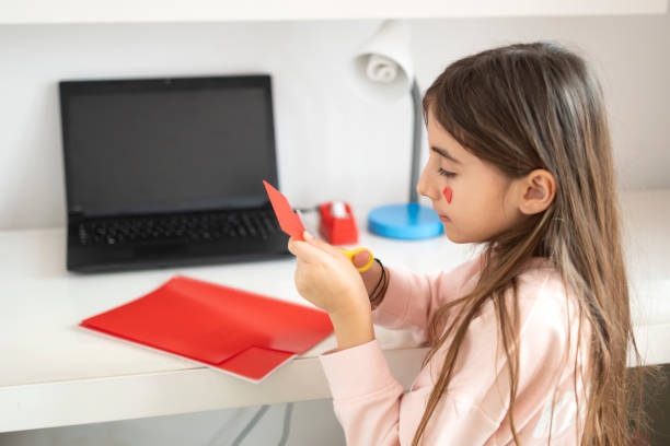 istock Littel girl cutting the plastic notebook 1308627741