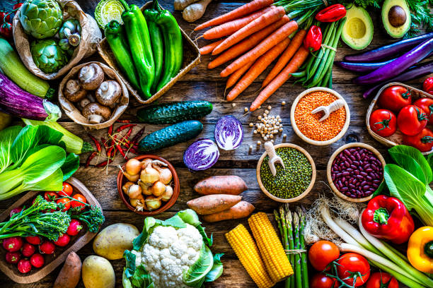 Healthy food: fresh organic vegetables and legumes shot from above on rustic wooden table