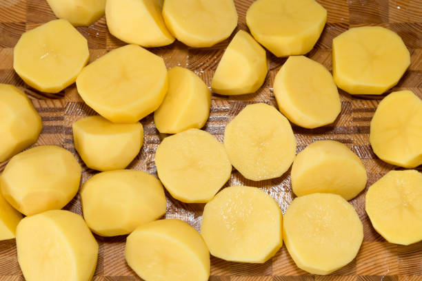 istock Coarsely chopped potatoes for cooking on wood board 1308631129