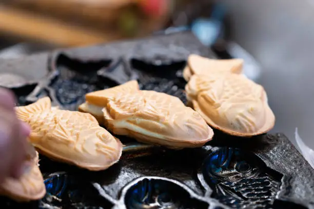 Close up of Taiyaki, fish shaped cake with red bean filling, thai street food market