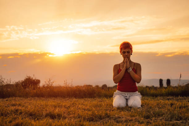 istock Pretty woman meditating on meadow 1308632256