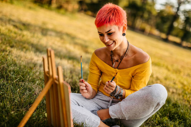 istock Woman painting on meadow 1308633076