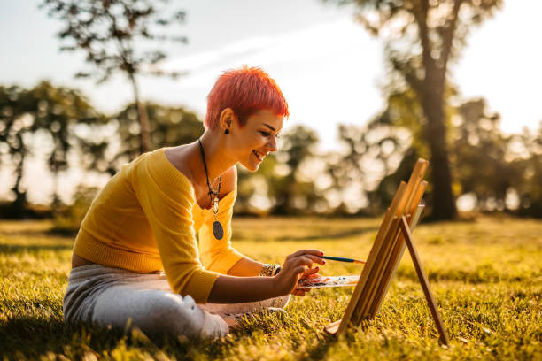 istock Woman painting on meadow 1308633201