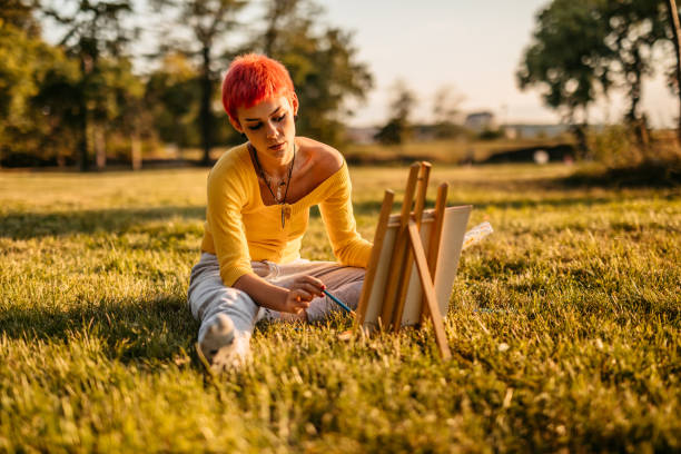 istock Woman painting on meadow 1308633279
