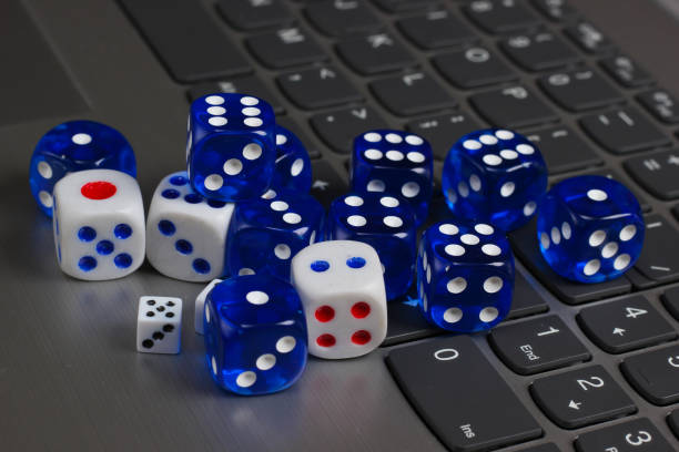 istock Many different dice on laptop keyboard close up 1308633372