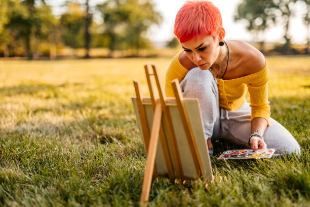 istock Woman painting on meadow 1308633490