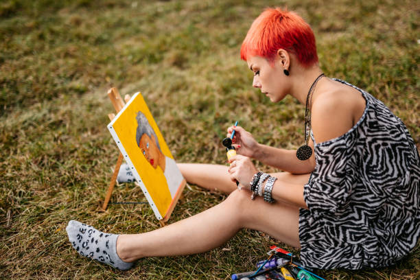 istock Woman painting on meadow 1308633541