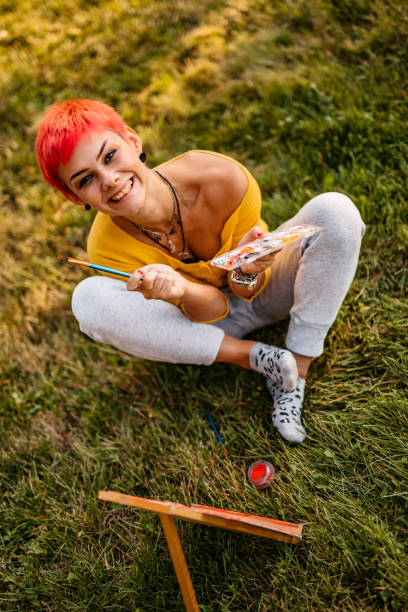 istock Woman painting on meadow 1308633655