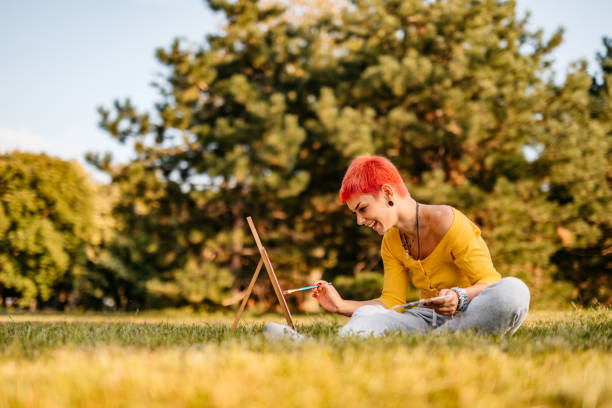 istock Woman painting on meadow 1308633909