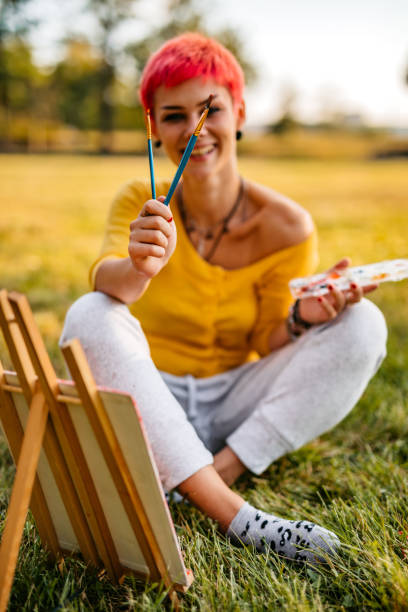 istock Woman painting on meadow 1308634035