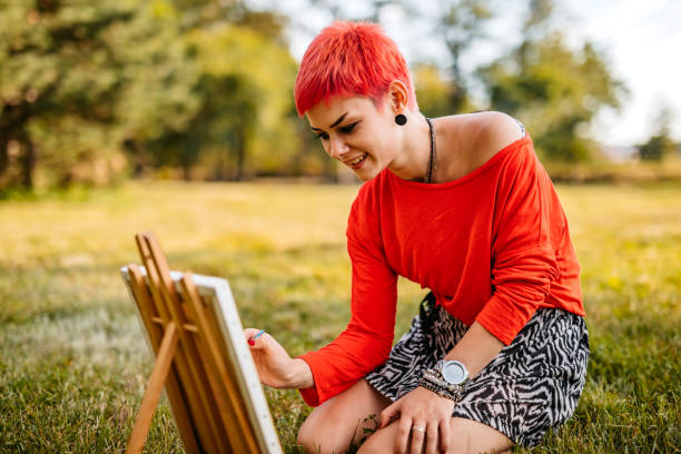 istock Woman painting on meadow 1308634077