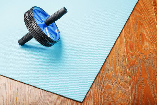istock Blue roller for abs pumping classes on a blue fitness Mat. 1308634855