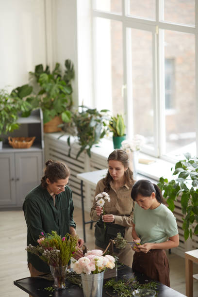 istock Group of People Creating Flower Bouquets in Workshop 1308635349