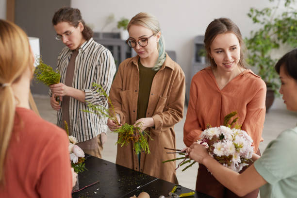 istock Group of People Creating Flower Compositions in Florists Workshop 1308635361