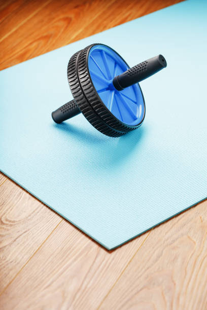 istock Blue roller for abs pumping classes on a blue fitness Mat. 1308635550