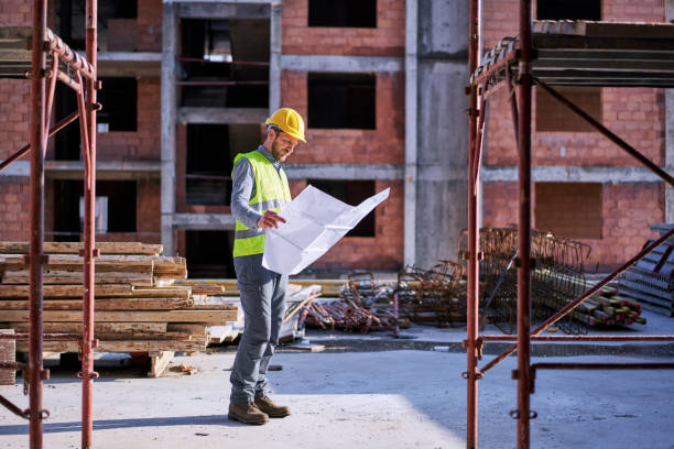 istock Architect checking the plans of the building on blueprints 1308637420