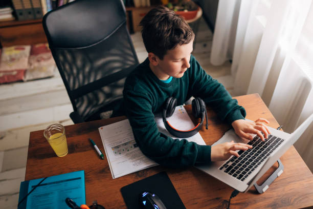 istock Homeschooled boy, using the wealth of technology to gain more knowledge and be productive during state lockdown because of COVID-19 pandemic 1308638047