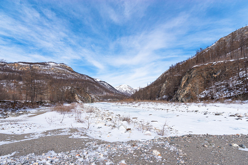 Winter landscape. Valley of the Irkut mountain river in early spring. Republic of Buryatia, Russia, Siberia.