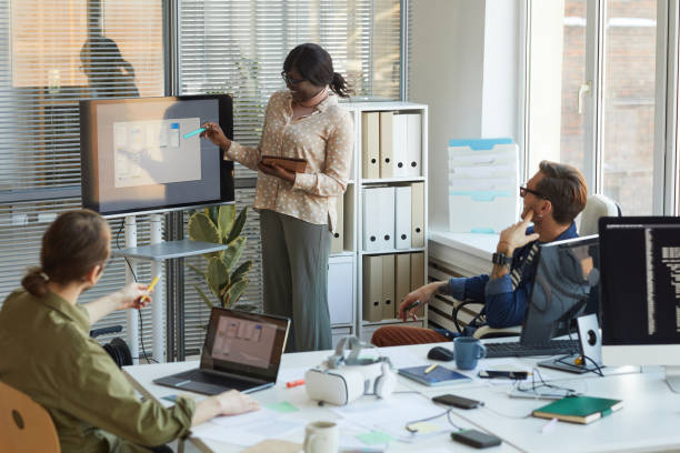 istock African American Woman Giving Presentation at IT Developers Meeting 1308639731