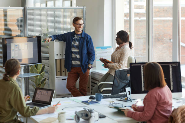 istock Team of IT Developers Discussing Project at Meeting 1308639746