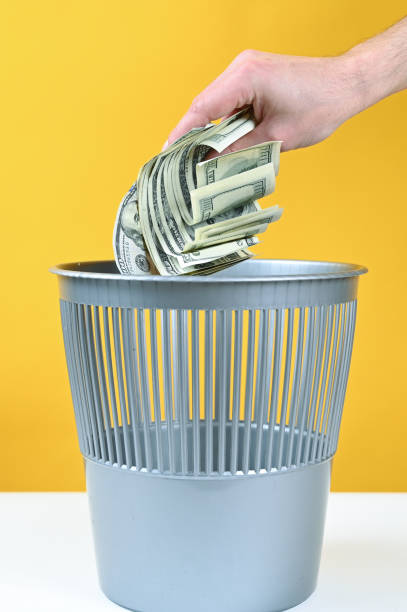 istock Money is thrown into the trash 1308640877
