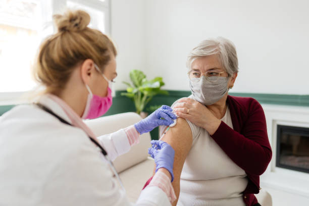 istock Senior woman's getting vaccinated at her home 1308641147