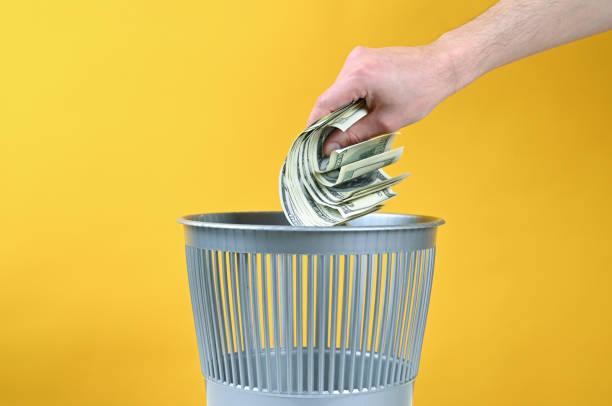 Money is thrown into the trash
