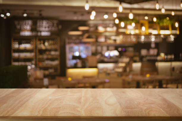 istock Blank wooden bar counter with defocused background. 1308643675
