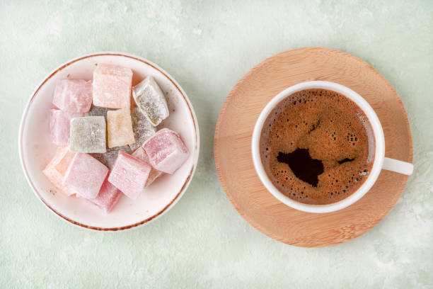istock cup of coffee and Turkish delights on a green table 1308643961